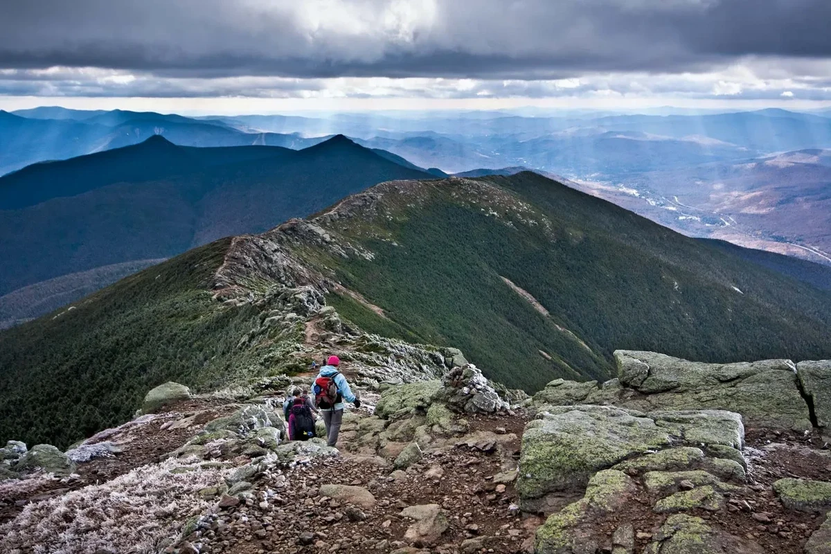 Hiking trail in the White Mountains of New Hampshire with scenic views.