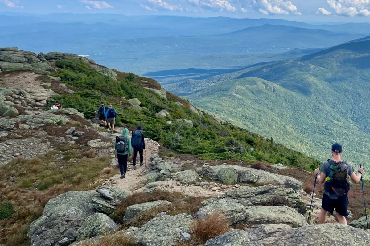 Hiker enjoying the scenic views in the White Mountains of New Hampshire.