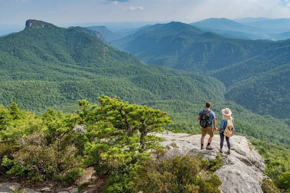 Hiker enjoying breathtaking scenic views on a mountain trail