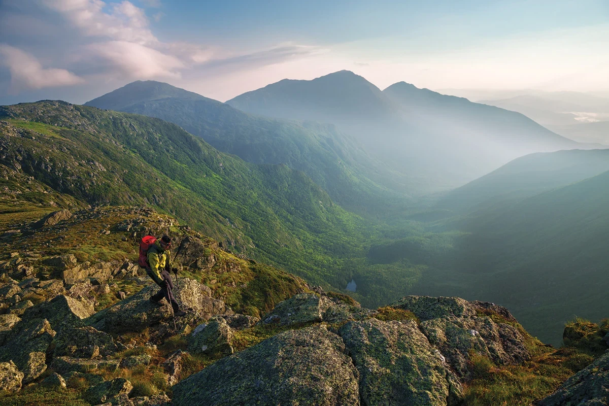 Hiker enjoying a scenic view in White Mountain National Forest