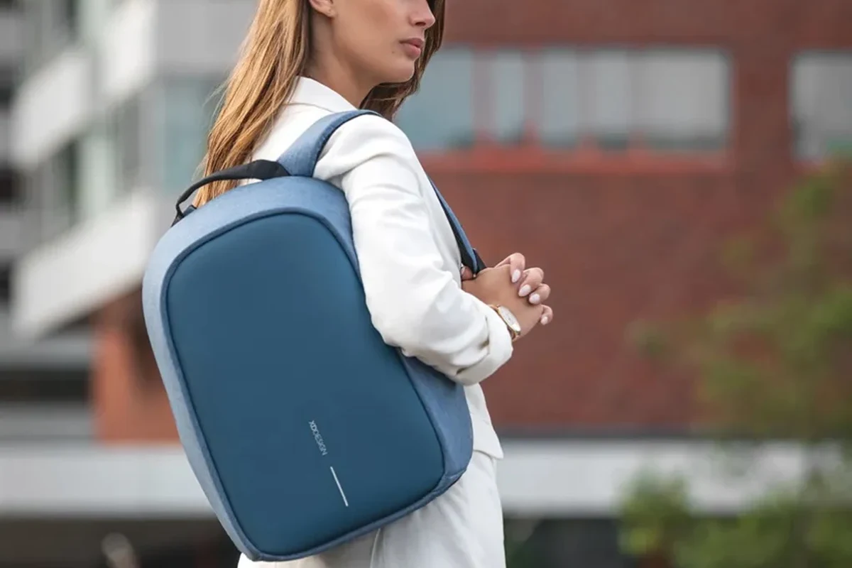 Woman carrying an anti theft business backpack while traveling.